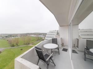 a balcony with a table and chairs on it at Studio High in the sky with amazing views by Interhome in De Haan