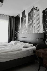 a bedroom with a bed with a city skyline at Super Stay Hotel, Oslo in Oslo