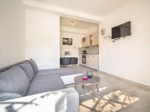 a living room with a couch and a table at Apartment Miškulin-4 by Interhome in Senj