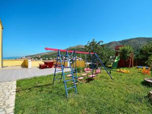 a playground with a slide in the grass at Apartment Miškulin-4 by Interhome in Senj