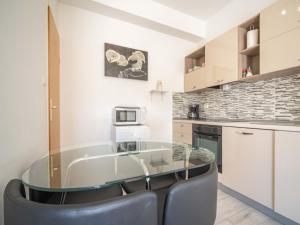 a kitchen with a glass table and chairs at Apartment Miškulin-4 by Interhome in Senj +29 photos