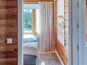 a small bedroom with a bed and a window at Holiday Home Riekkotupa by Interhome in Enontekiö +17 photos