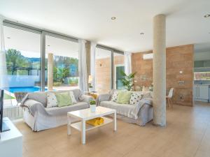 een woonkamer met 2 banken en een tafel bij Villa Villa Carme by Interhome in Colonia de Sant Pere