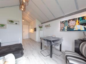 a living room with a table and a couch at Apartment La Bella Vita parking and shared pool by Interhome in De Haan