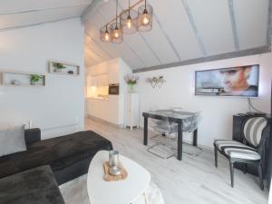 a living room with a couch and a table at Apartment La Bella Vita parking and shared pool by Interhome in De Haan +23 photos