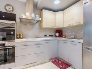 a kitchen with white cabinets and a sink at Apartment Bidassoa by Interhome in Hendaye