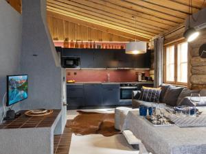 a living room with a couch and a kitchen at Holiday Home Lumiankelo by Interhome in Sirkka