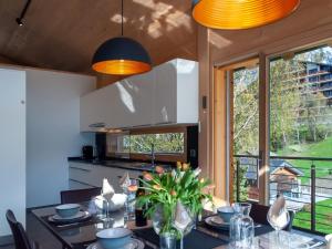 a kitchen and dining room with a table and chairs at Chalet Les Penguins by Interhome in Nendaz