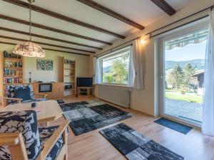 a living room with a table and a large window at Apartment Am Hohen Bogen-58 by Interhome in Kummersdorf