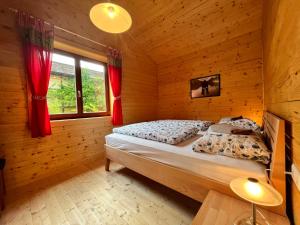 a bedroom with a bed in a wooden cabin at Chalet Stressless by Interhome in Presseggen