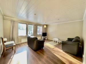a living room with two couches and a tv at Apartment Kalliokuja in Pyhäjoki
