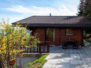a small wooden cabin with a bench in front of it at Chalet Dolce Cabane by Interhome in Nendaz