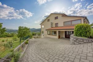 a house with a driveway in front of it at Holiday House Aida with Private Pool in Buzet