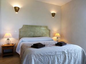 a bedroom with a bed with two black bags on it at Villa Villa Orizonte by Interhome in Favone