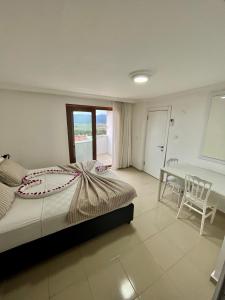 a bedroom with a bed and a table and a desk at Koparan Apart Hotel in Akyaka