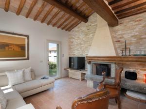 a living room with a couch and a fireplace at Villa Oliva by Interhome in Querce