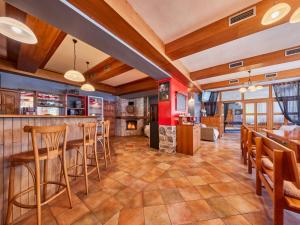 a dining room with a bar and a fireplace at Chalet Krakonoš by Interhome in Mladé Buky +67 photos