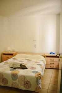 a bedroom with a bed with a purse on it at The Little House in Glífa