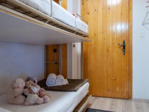A bed or beds in a room at Apartment Les Diablerets by Interhome
