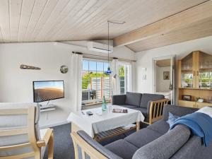 a living room with a couch and a table at Holiday Home Amy - 150m from the sea in Funen by Interhome in Otterup