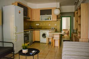 a kitchen with a refrigerator and a table in a room at The Little House in Glida