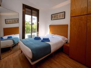 a bedroom with a bed with blue towels on it at Apartment Barcelona Centric Apartment by Interhome in Barcelona
