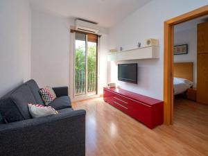 a living room with a couch and a television at Apartment Barcelona Centric Apartment by Interhome in Barcelona