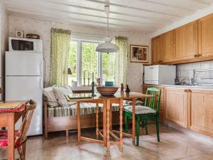 a kitchen with a table and a dining room at Chalet Smedstorp by Interhome in Tibro +14 photos