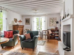 a living room with two chairs and a fireplace at Chalet Smedstorp by Interhome in Tibro