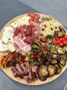 a plate of food with meat and vegetables on a table at L'instant d'un séjour in Le Guâ