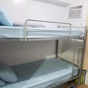 a couple of bunk beds in a room at Family Group Affordable Staycation in tagaytay in Tagaytay