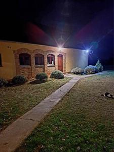 a house at night with two lights on at Csodarét Kúria in Mórahalom