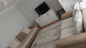 a living room with a couch and a flat screen tv at Doğal apart in Trabzon