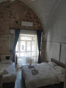 Ліжко або ліжка в номері ŞAHMARAN BUTİK OTEL