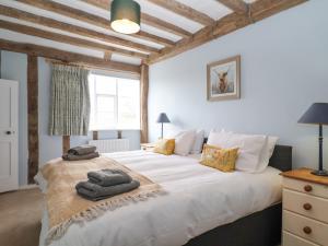 a bedroom with a large white bed and a window at South Grange House in Sibton