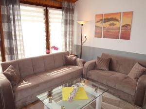 a living room with two couches and a coffee table at Apartment Strandkorb by Interhome in Hooksiel