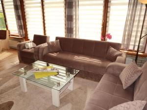 a living room with a couch and a coffee table at Apartment Strandkorb by Interhome in Hooksiel