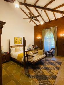 a bedroom with a bed and a ceiling fan at The Postcard Saligao in Calangute