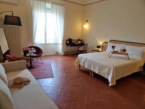 Postel nebo postele na pokoji v ubytování Palazzo Rosselmini