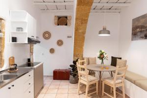 a kitchen and dining room with a table and chairs at Tethys 2 by Cretan Pnoe Adults Only in Chania