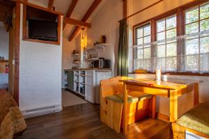 a living room with a table and a kitchen at Edelweiss Inn Nova Scotia in Middleton