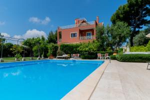 a villa with a swimming pool in front of a house at Villa Luisa in Bari