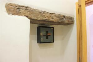 a log on the wall of a room with a mirror at Avli House Vori in Vóroi