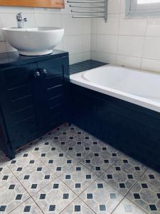 a bathroom with a sink and a bath tub at Nandy's home in Odza II