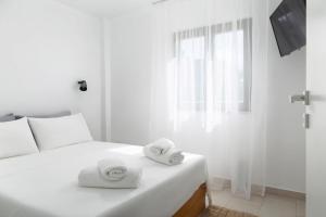 Postel nebo postele na pokoji v ubytování Lemoni House
