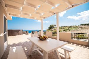 a dining room with a table and a view of the ocean at Serenitas, family house with great views in Sfakia