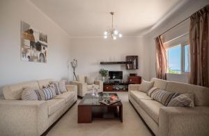 a living room with two couches and a coffee table at Serenitas, family house with great views in Sfakia