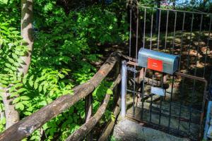 um portão de metal com um sinal. em Casa al Fiume by Quokka 360 - House by the River in the Verzasca Valley em Lavertezzo