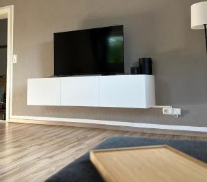 a living room with a television on a white cabinet at Apartment in Weiden i. d. Opf. in Weiden