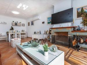 a living room with a fireplace and a flat screen tv at Holiday Home Aguilera by Interhome in Maçanet de la Selva